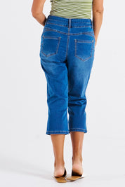 A model wearing the Alessi Crop Jean in colour Trueblue (Blue), from the back