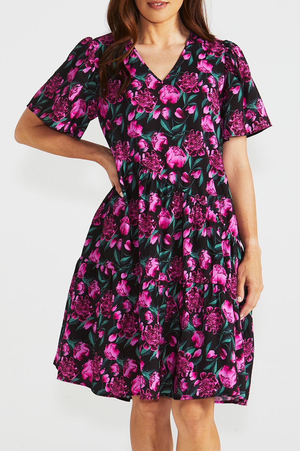 A model wearing the Florence Tiered Dress in colour Floral (Pink), from the front, cropped image
