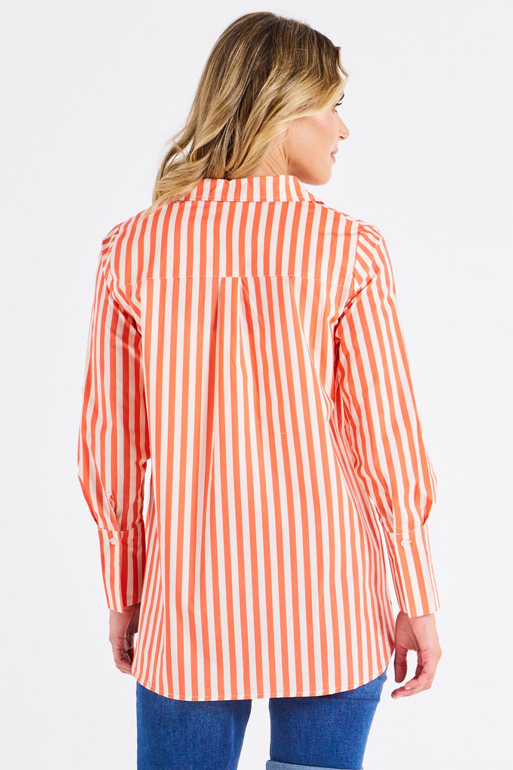 A model wearing the Camden Cotton Shirt in colour Tangerine, from the back