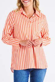 A model wearing the Camden Cotton Shirt in colour Tangerine, from the front, cropped image