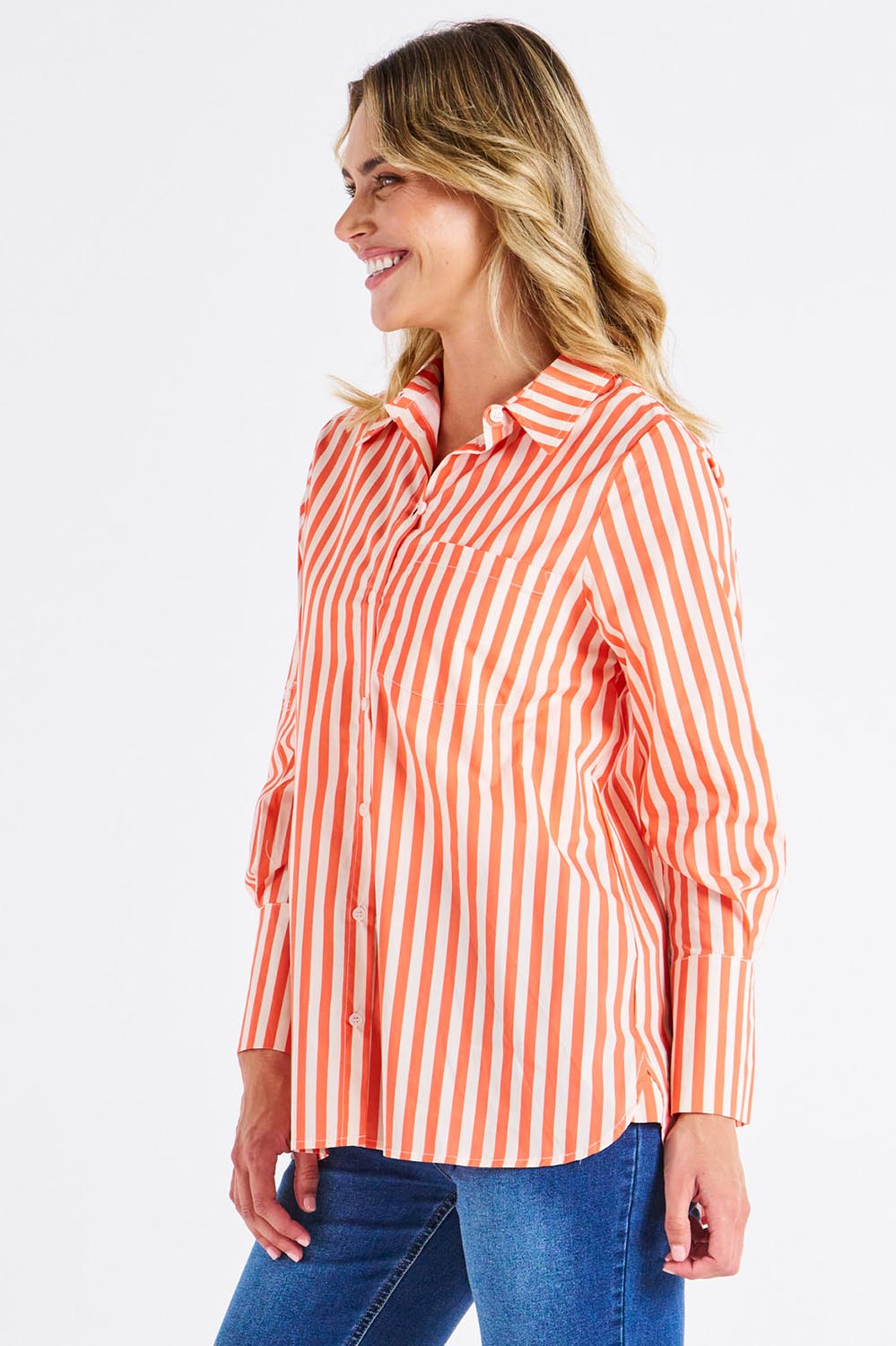 A model wearing the Camden Cotton Shirt in colour Tangerine, from the front, cropped image