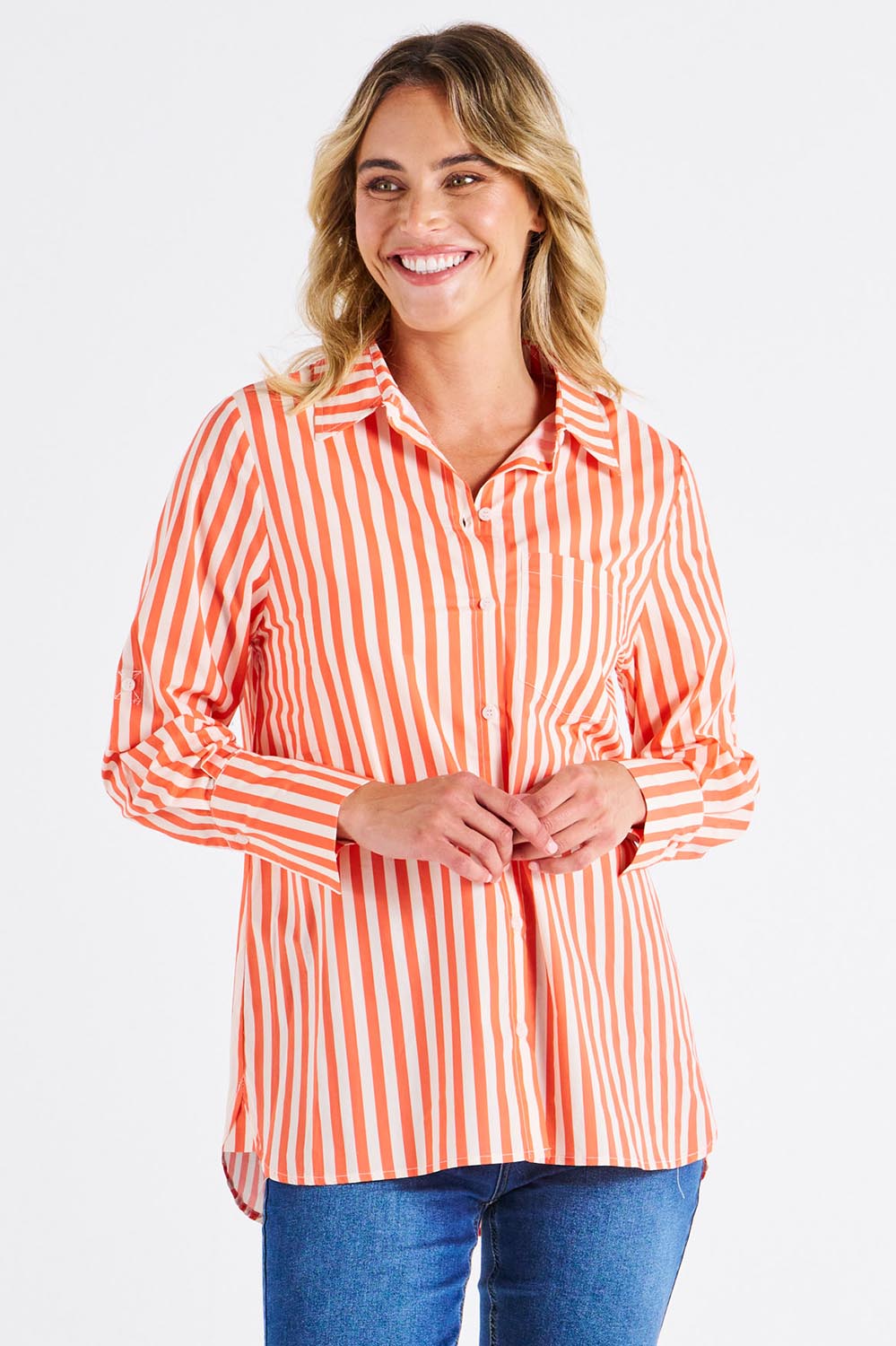 A model wearing the Camden Cotton Shirt in colour Tangerine, from the front, cropped image