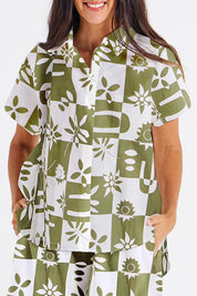 A model wearing the Mara Cotton Shirt in colour Geofloral (Green), from the front, cropped image