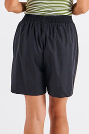 A model wearing the Pomona Cotton Short in colour Black (Black), from the back