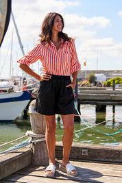 A model wearing the Pomona Cotton Short in colour Black (Black), from the front, showing the whole outfit