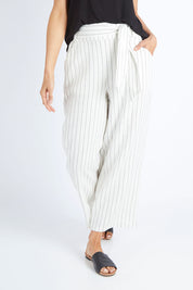 Model Gemma wearing size 10 of the Keto Pant in colour Pinstripe (White), from the front, cropped image