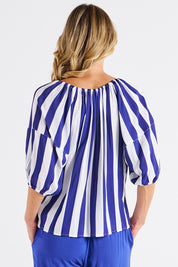 A model wearing the Camilla Blouse in colour Bluestripe (Blue), from the back