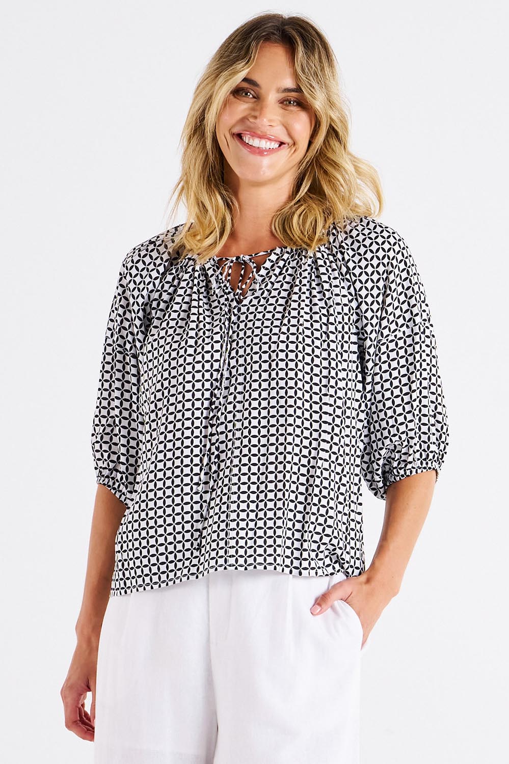 A model wearing the Camilla Blouse in colour Geometric (Black), from the front, cropped image
