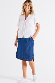 A model wearing the Sandy Shirred Blouse in colour White (White), from the front, showing the whole outfit
