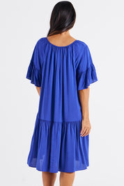 A model wearing the Bella Dress in colour Blue (Blue), from the back