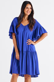 A model wearing the Bella Dress in colour Blue (Blue), from the front, cropped image