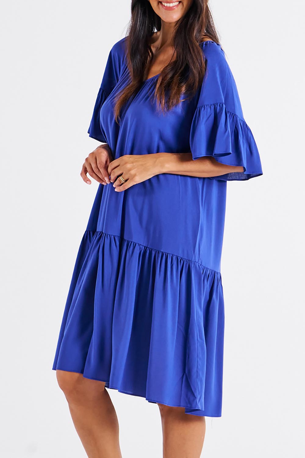 A model wearing the Bella Dress in colour Blue (Blue), from the front, cropped image