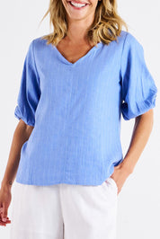 A model wearing the Elanora Linen Blend Blouse in colour Berryblue (Blue), from the front, cropped image