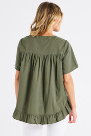 A model wearing the Candice Cotton Blouse in colour Olivbranch (Green), from the back