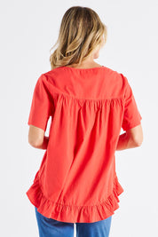 A model wearing the Candice Cotton Blouse in colour Watermelon, from the back