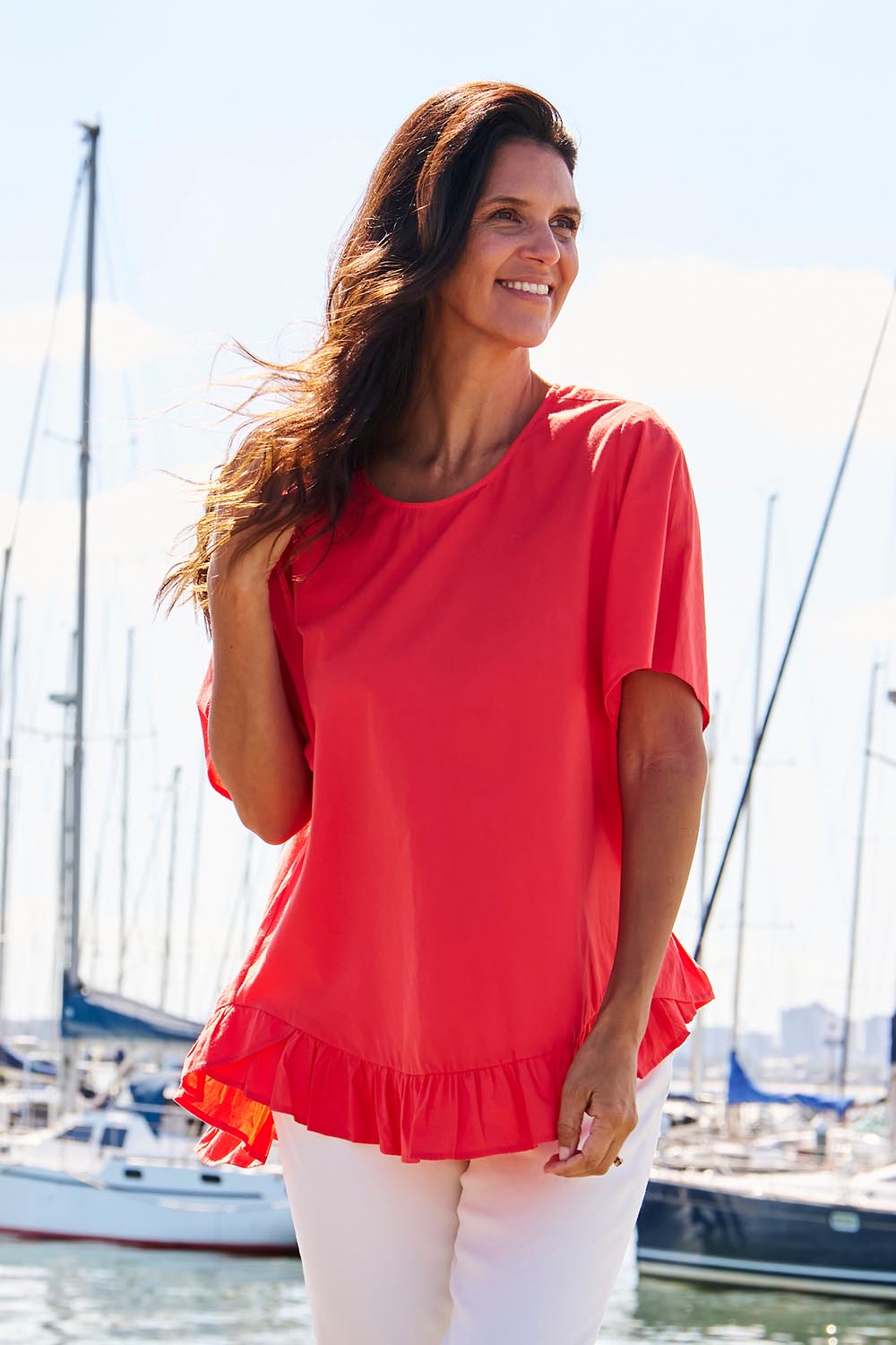 A model wearing the Candice Cotton Blouse in colour Watermelon, from the front, showing the whole outfit
