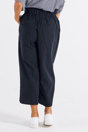 A model wearing the Cabo Cotton Crop Pant in colour Black (Black), from the back