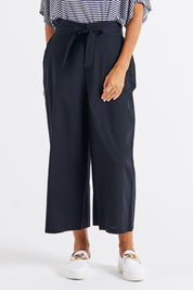A model wearing the Cabo Cotton Crop Pant in colour Black (Black), from the front, cropped image