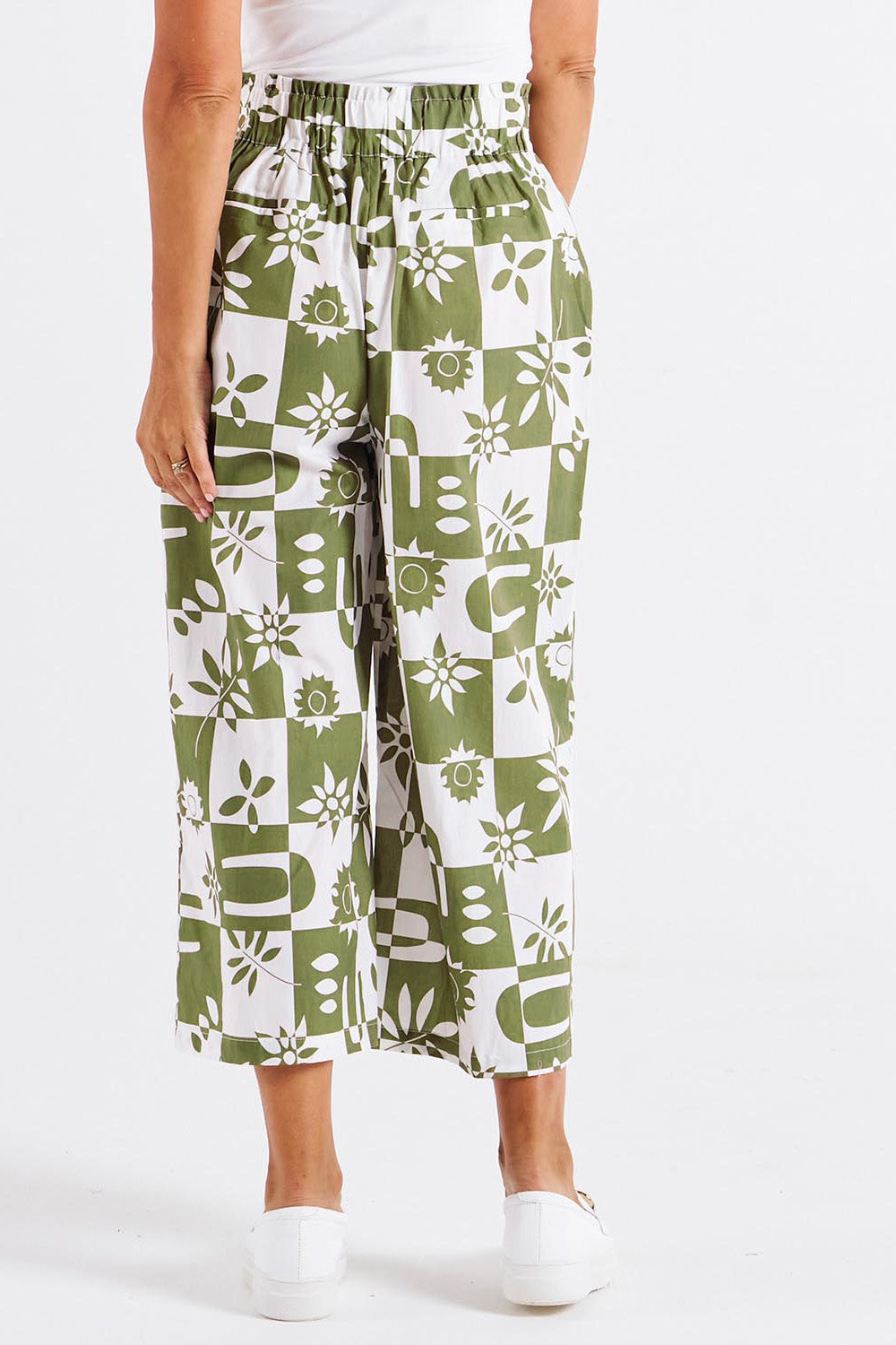A model wearing the Cabo Cotton Crop Pant in colour Geofloral (Green), from the back