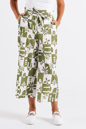 A model wearing the Cabo Cotton Crop Pant in colour Geofloral (Green), from the front, cropped image