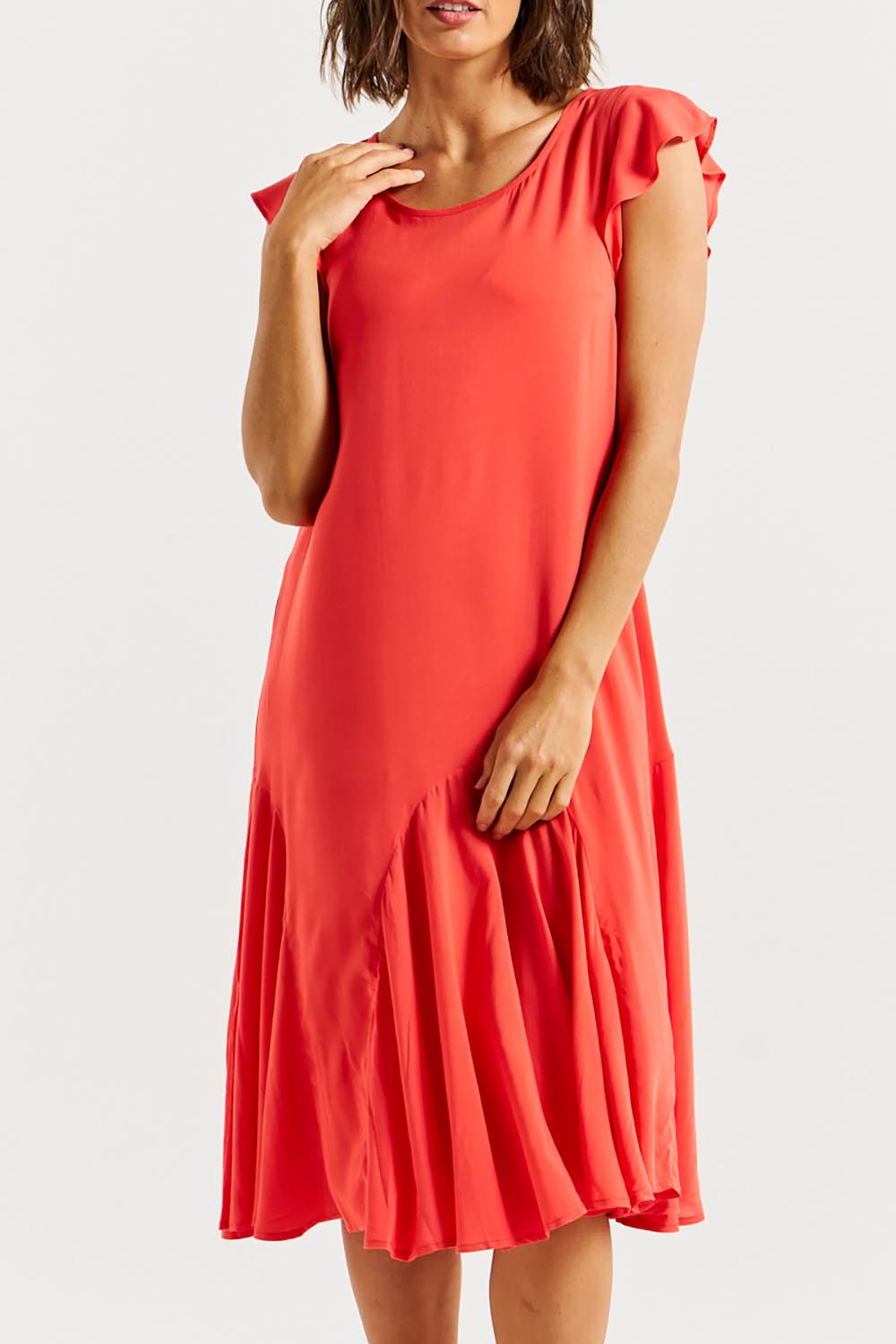 A model wearing the Hannah Dress in colour Fiestared (Red), from the front, cropped image