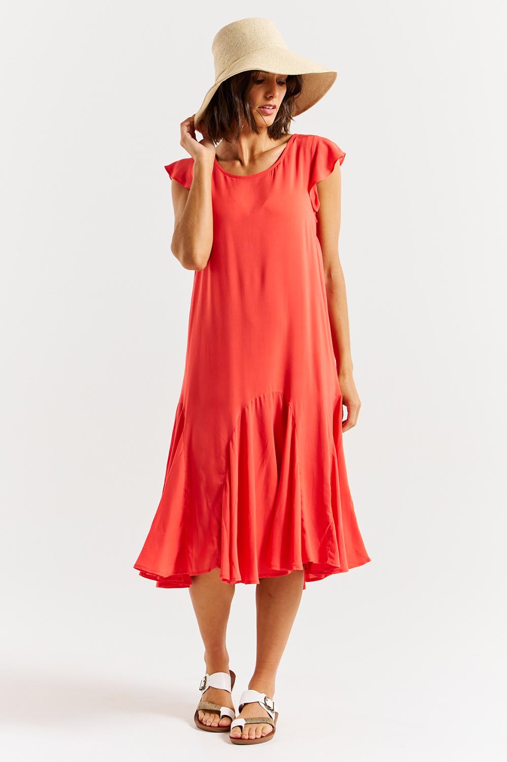 A model wearing the Hannah Dress in colour Fiestared (Red), from the front, showing the whole outfit