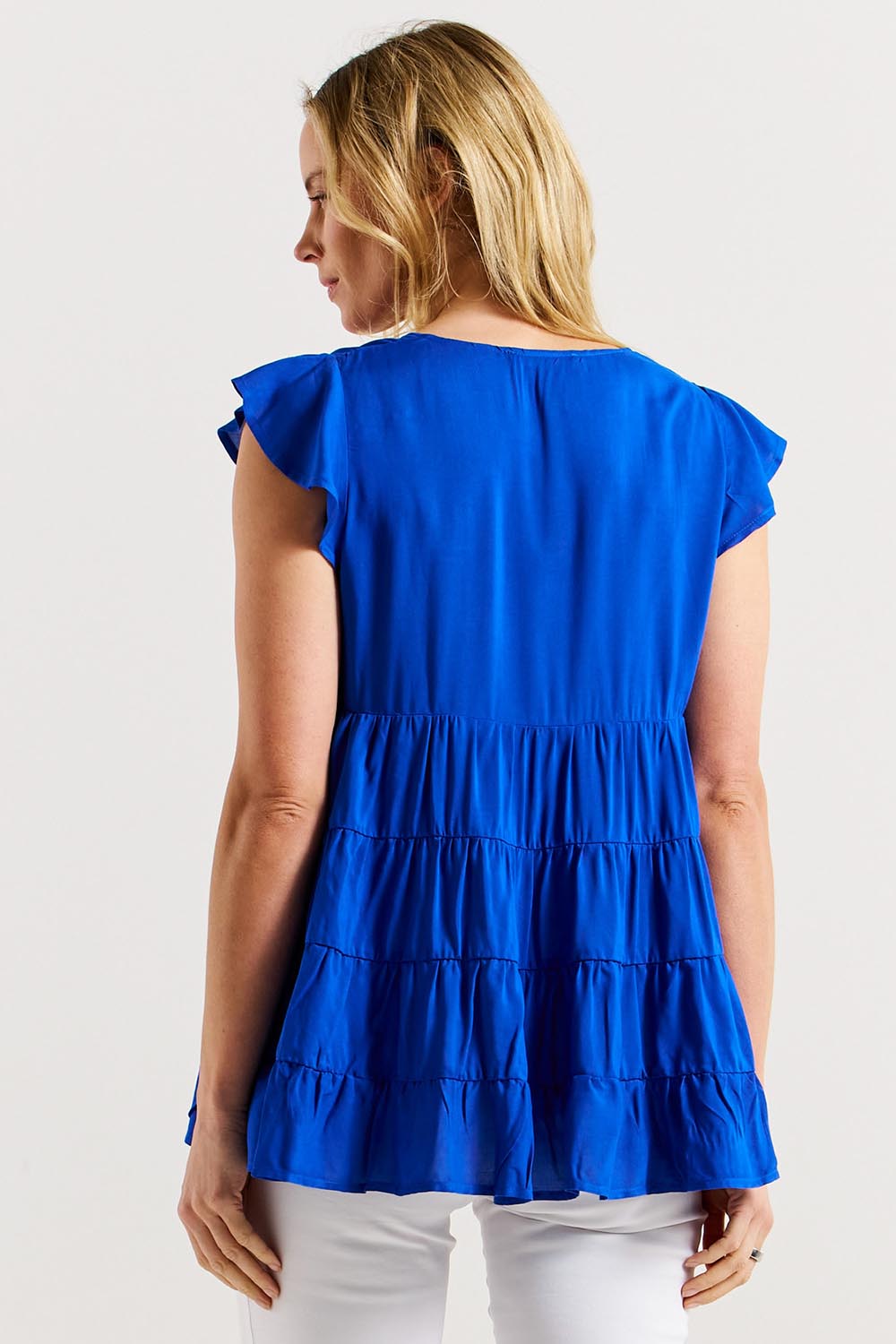 A model wearing the Danica Frill Top in colour Cobalt (Blue), from the back