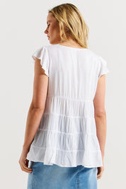 A model wearing the Danica Frill Top in colour White (White), from the back