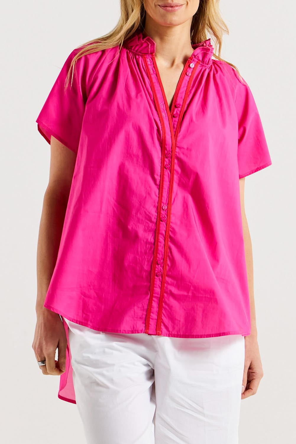 A model wearing the Caspian Cotton Blouse in colour Pinkred (Pink), from the front, cropped image