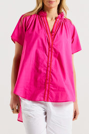 A model wearing the Caspian Cotton Blouse in colour Pinkred (Pink), from the front, cropped image