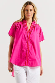 A model wearing the Caspian Cotton Blouse in colour Pinkred (Pink), from the front, cropped image