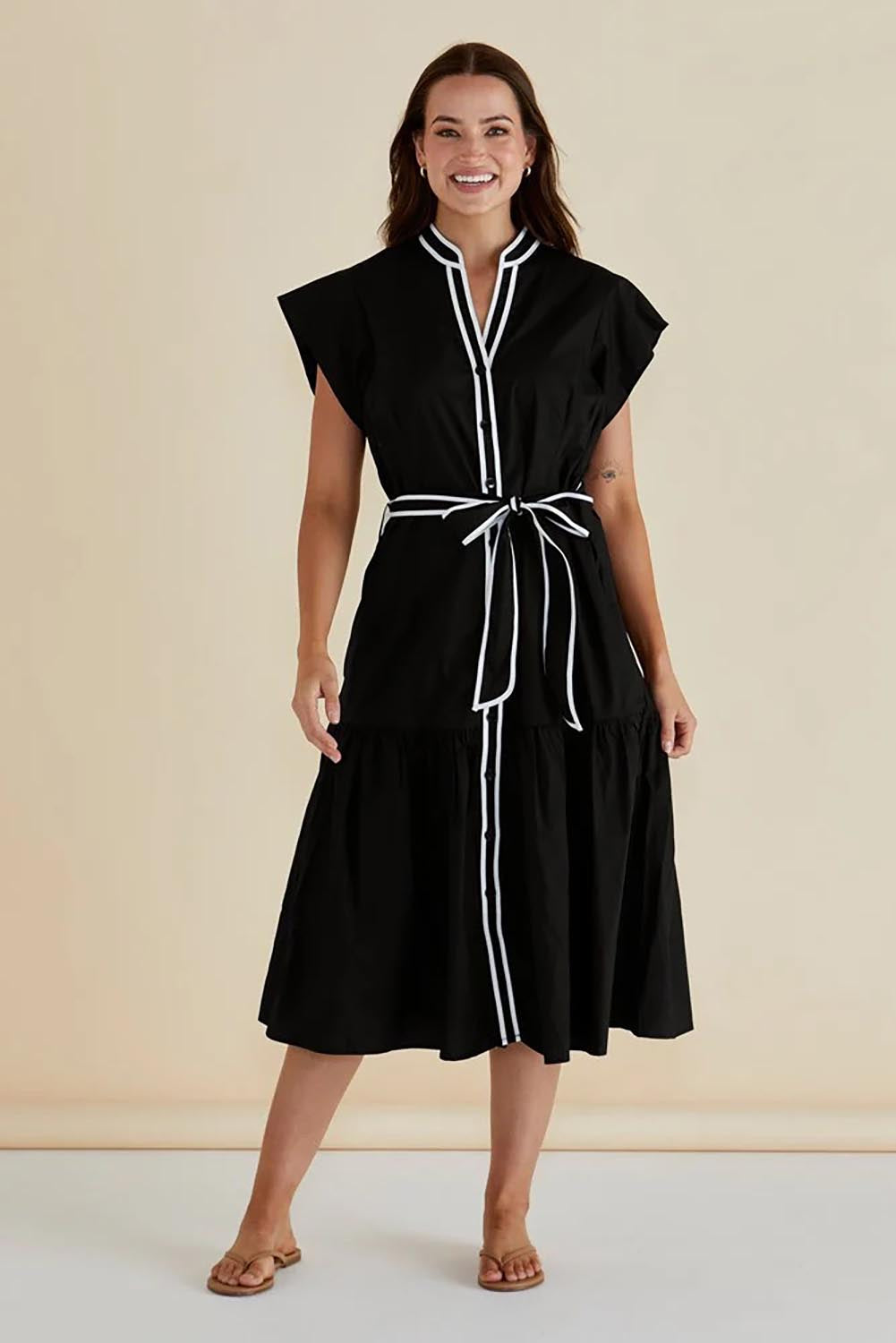 A model wearing the Mari Cotton Dress in colour Black (Black), from the front, showing the whole outfit