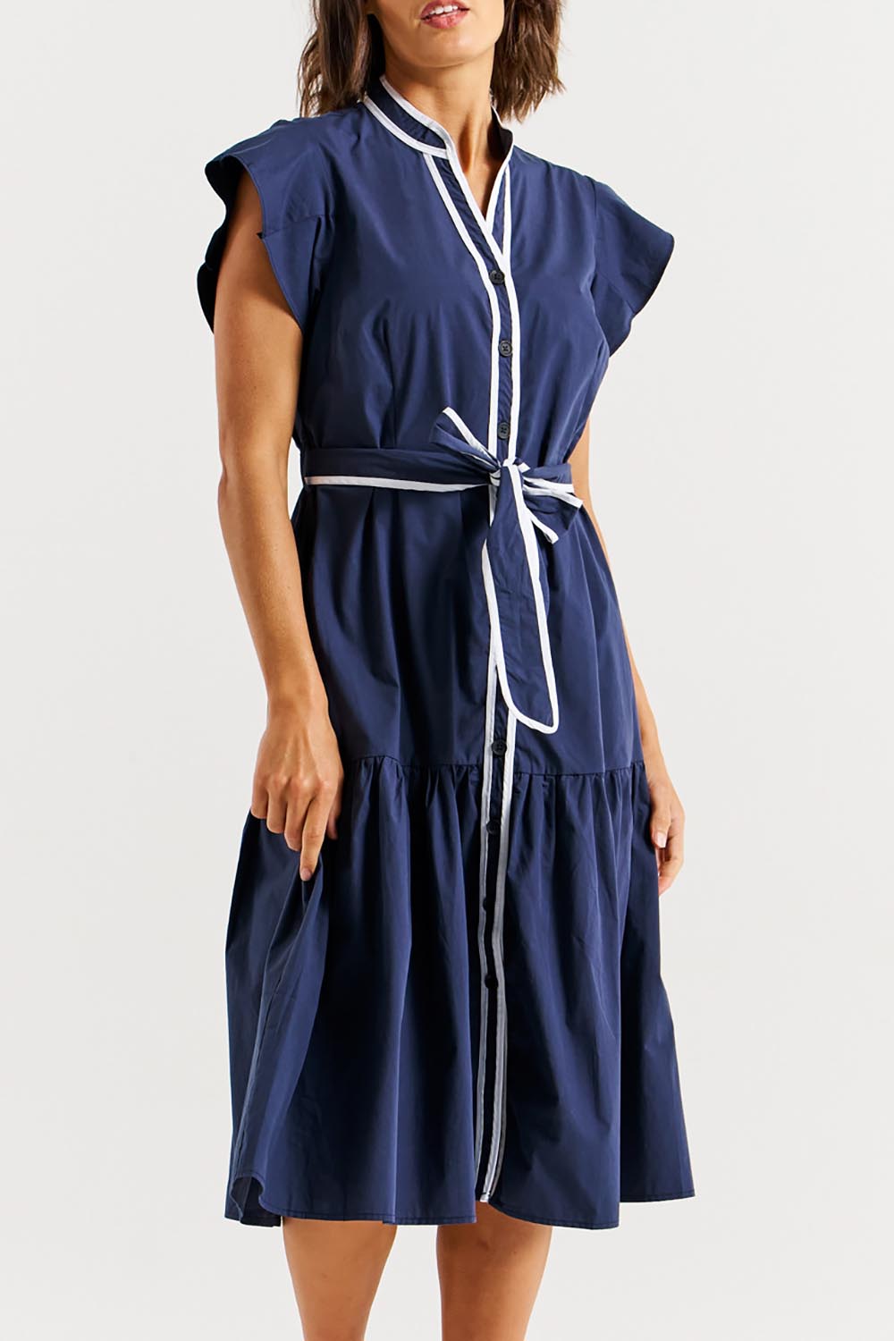 A model wearing the Mari Cotton Dress in colour Navywhite (Blue), from the front, cropped image