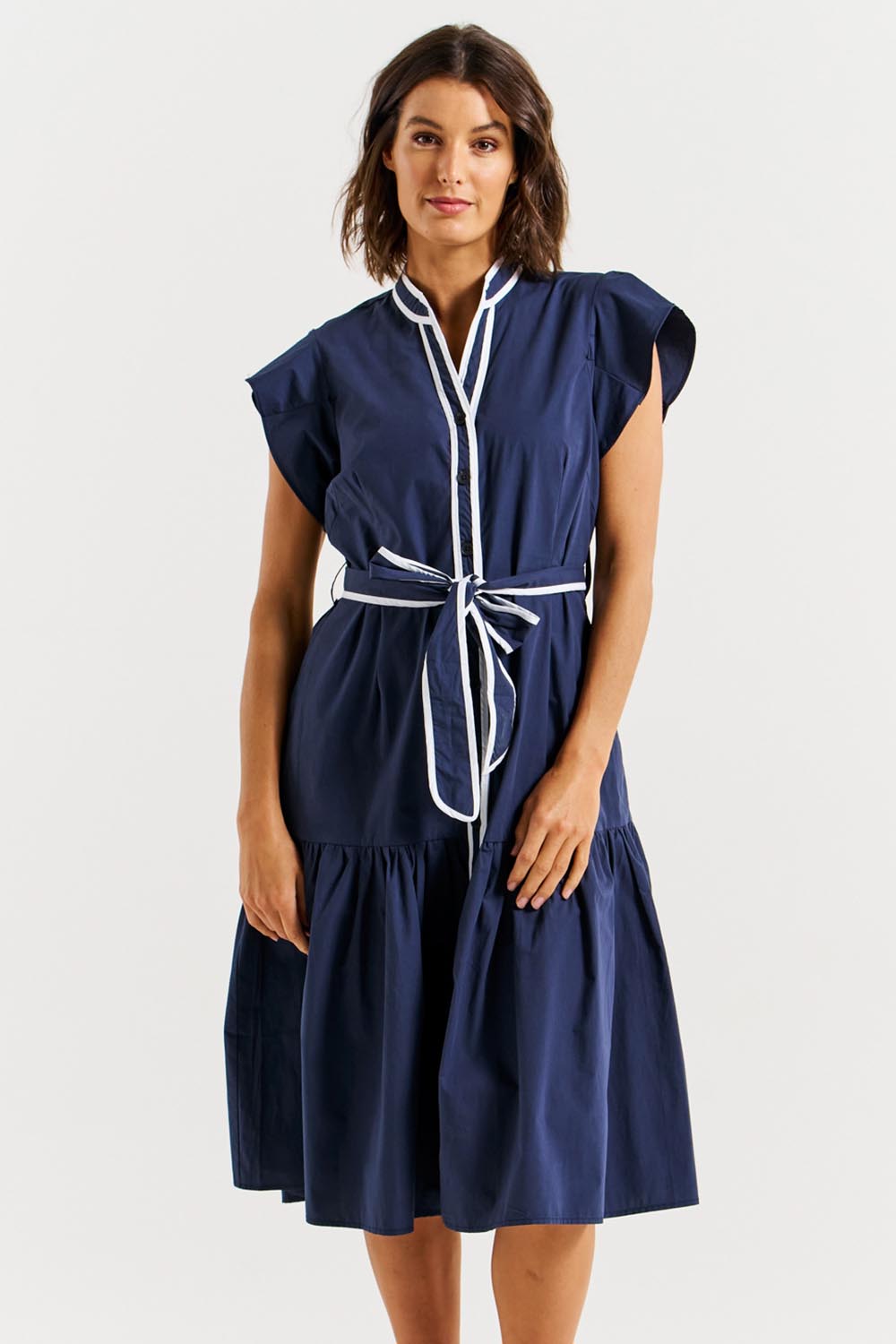 A model wearing the Mari Cotton Dress in colour Navywhite (Blue), from the front, cropped image