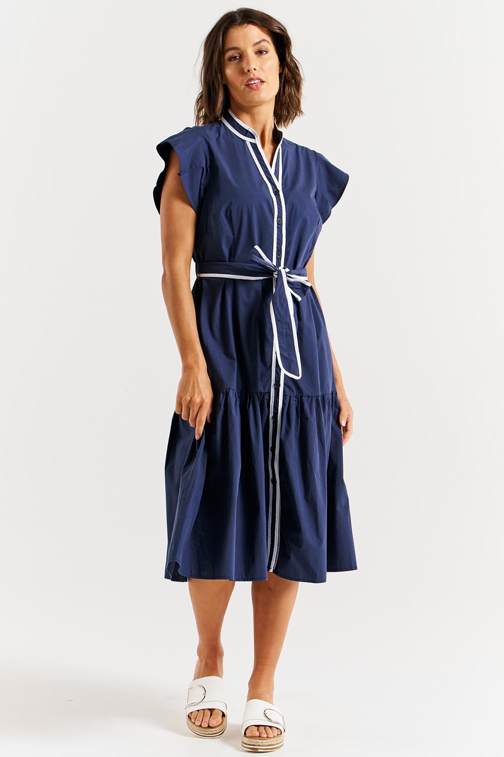 A model wearing the Mari Cotton Dress in colour Navywhite (Blue), from the front, showing the whole outfit