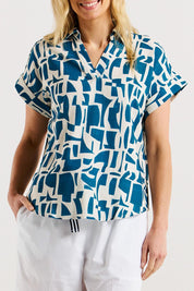 A model wearing the Flores Linen Blend Blouse in colour Geoprint (Blue), from the front, cropped image