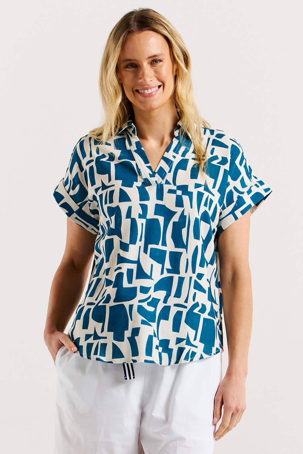 A model wearing the Flores Linen Blend Blouse in colour Geoprint (Blue), from the front, cropped image