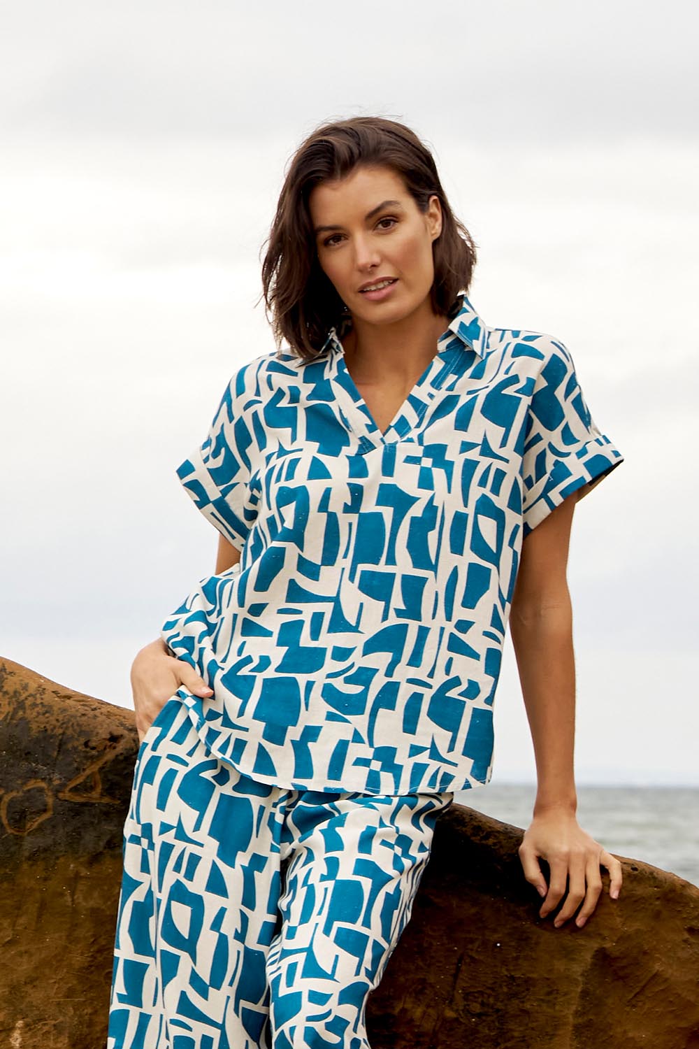 A model wearing the Flores Linen Blend Blouse in colour Geoprint (Blue), from the front, showing the whole outfit
