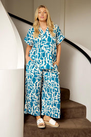 A model wearing the Senorita Linen Blend Pant in colour Geoprint (Blue), from the front, showing the whole outfit