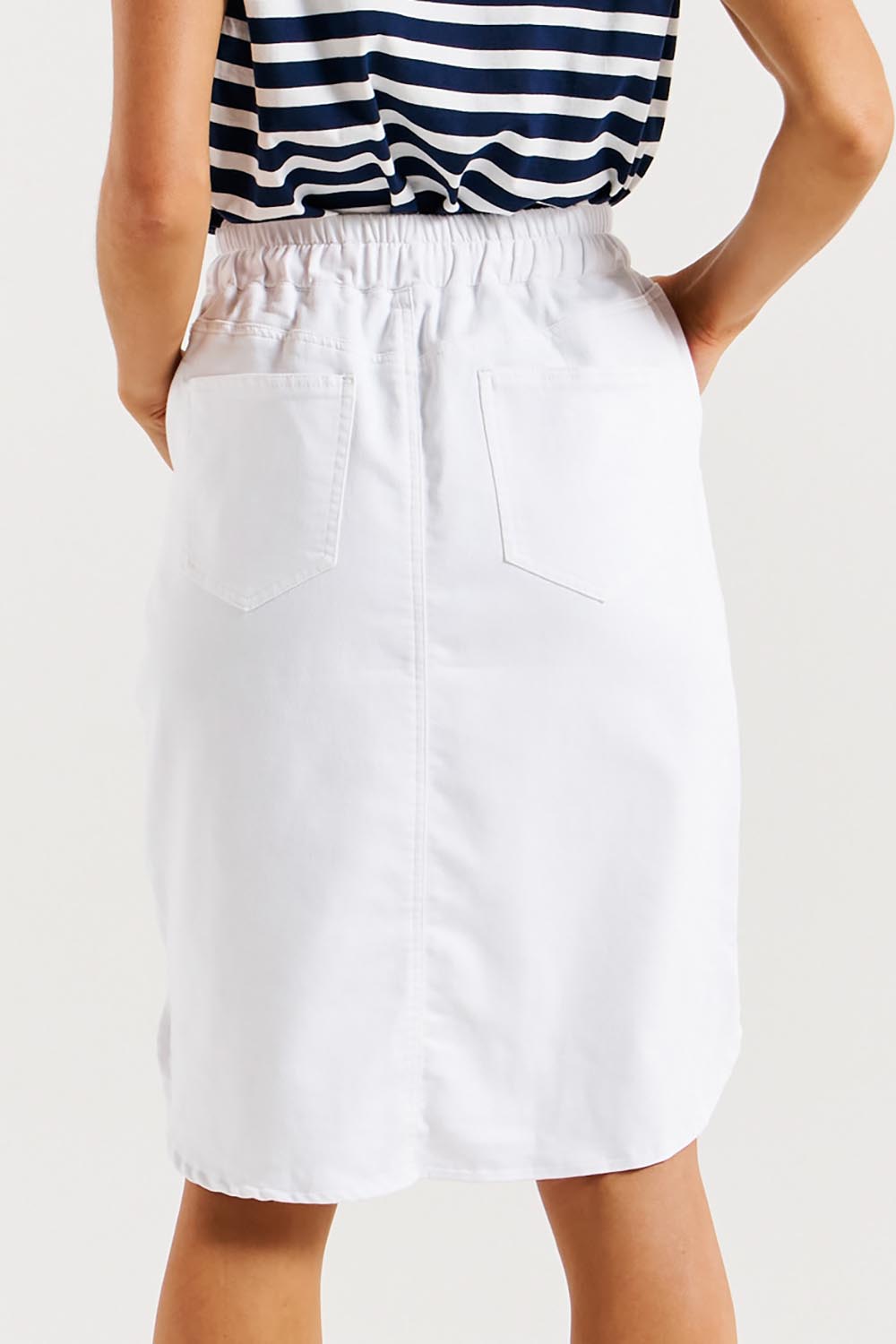 A model wearing the Alina Denim Skirt in colour White (White), from the back