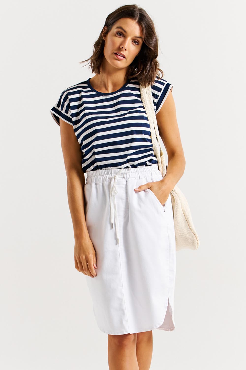 A model wearing the Alina Denim Skirt in colour White (White), from the front, cropped image
