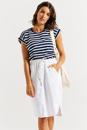 A model wearing the Alina Denim Skirt in colour White (White), from the front, cropped image