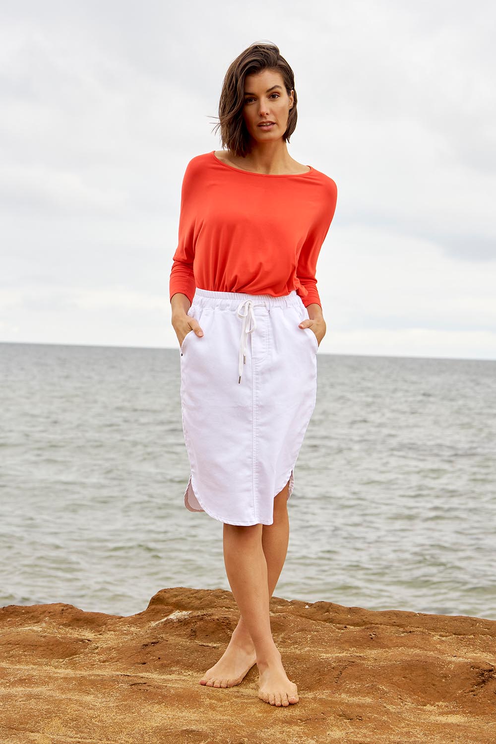A model wearing the Alina Denim Skirt in colour White (White), from the front, showing the whole outfit