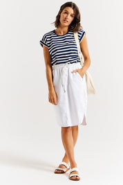 A model wearing the Alina Denim Skirt in colour White (White), from the front, showing the whole outfit
