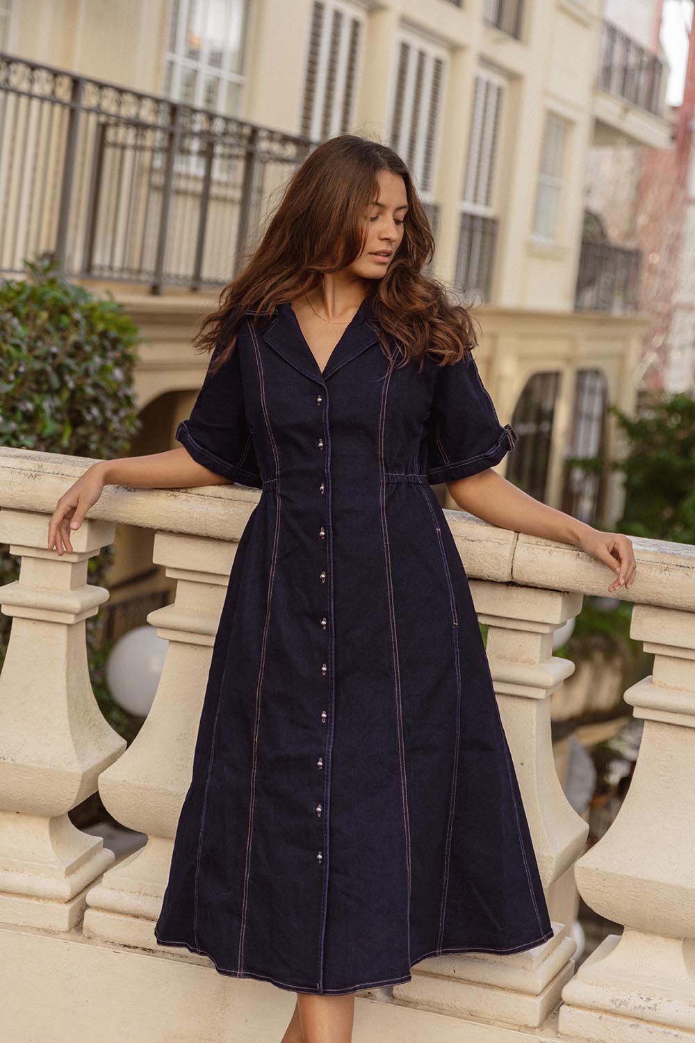 A model wearing the Dana Denim Dress in colour Rawindigo (Blue), from the front, showing the whole outfit