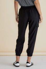 A model wearing the Adrianna Jogger in colour Black (Black), from the back