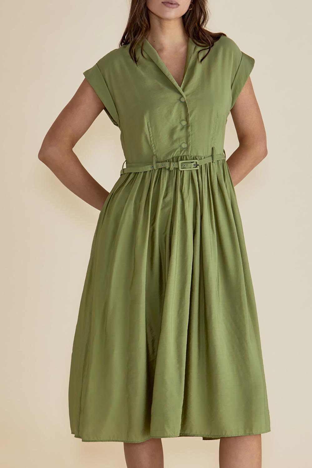 A model wearing the Elianna Dress in colour Pistachio (Green), from the front, cropped image