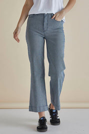 A model wearing the Willow Wide Leg Jean in colour Pinstripe (Blue), from the front, cropped image