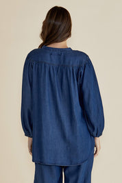A model wearing the London Lyocell Blouse in colour Darkindigo (Blue), from the back