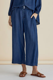 A model wearing the Rio Lyocell Relaxed Pant in colour Darkindigo (Blue), from the front, cropped image